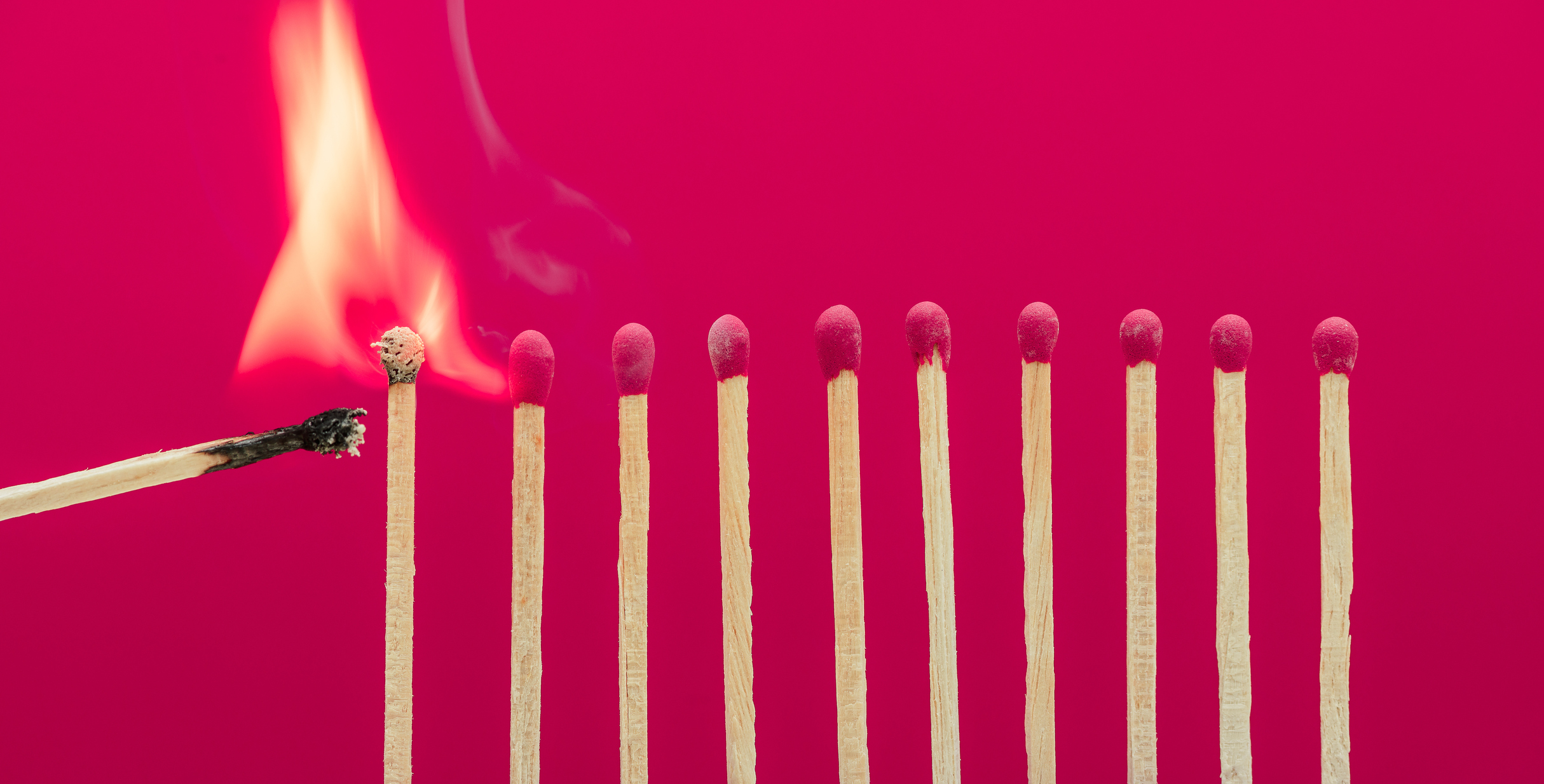 Burning matchsticks setting fire to its neighbors